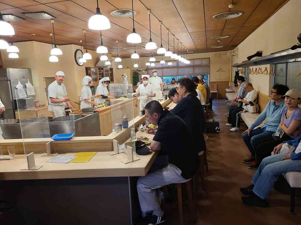 The bustling interior! The entire restaurant is basically one giant chef's counter. The seating area on the right is actually the waiting bench!