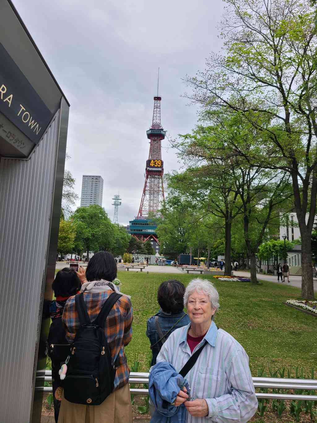 A beautiful, serene park with the iconic Sapporo TV tower standing tall in the background.